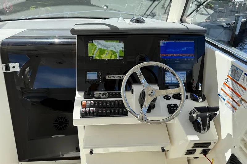 Centra Yacht Photos Pics 2023 Pursuit OS 355 Offshore helm with navigation screens and controls.
