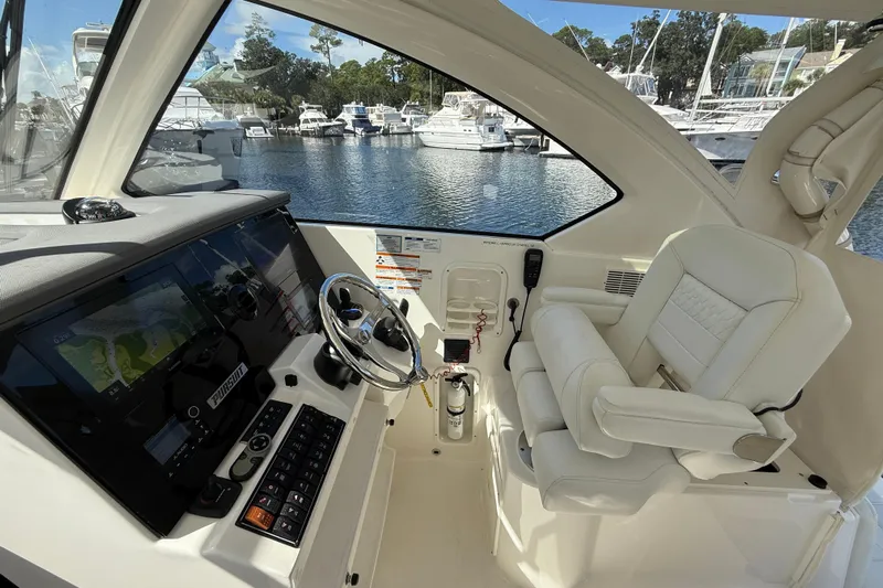 Centra Yacht Photos Pics 2023 Pursuit OS 355 Offshore helm with modern controls and luxurious seating.