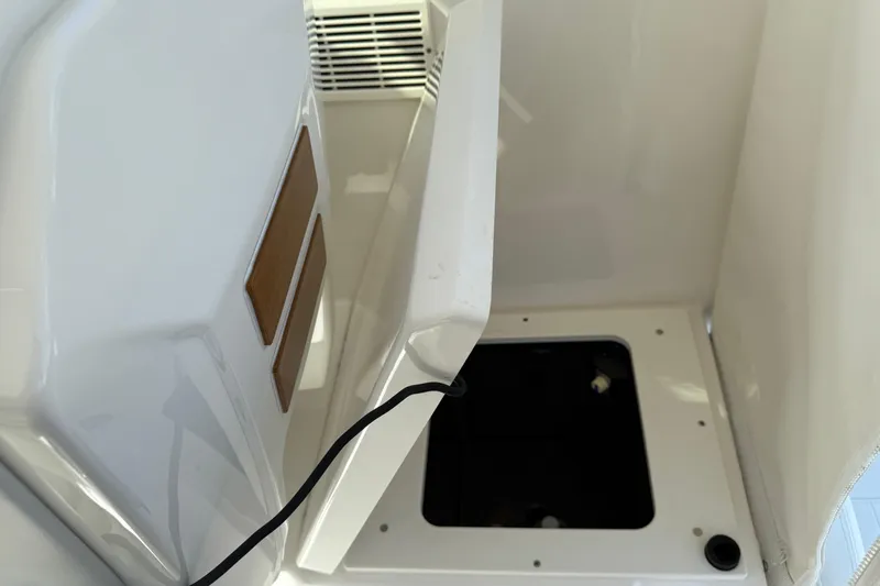 Centra Yacht Photos Pics 2023 Pursuit OS 355 Offshore boat interior storage compartment with open hatch.