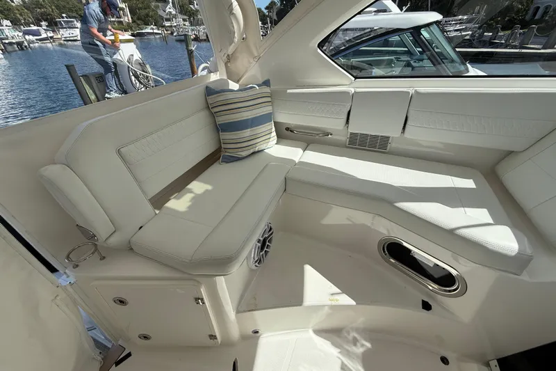 Centra Yacht Photos Pics 2023 Pursuit OS 355 Offshore boat interior with white seating and striped cushion.