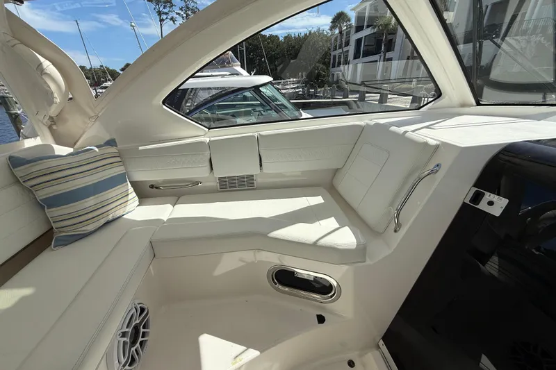 Centra Yacht Photos Pics 2023 Pursuit OS 355 Offshore boat interior with white seating and striped cushion.