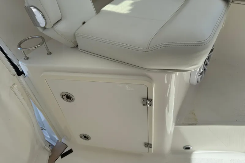 Centra Yacht Photos Pics 2023 Pursuit OS 355 Offshore boat interior with white seating and storage compartment.