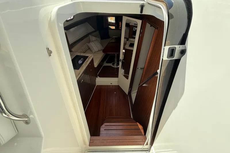 Centra Yacht Photos Pics Interior view of 2023 Pursuit OS 355 Offshore boat, featuring elegant wood finishes.