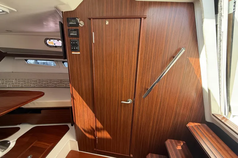 Centra Yacht Photos Pics 2023 Pursuit OS 355 Offshore cabin interior with wood finish and modern design.