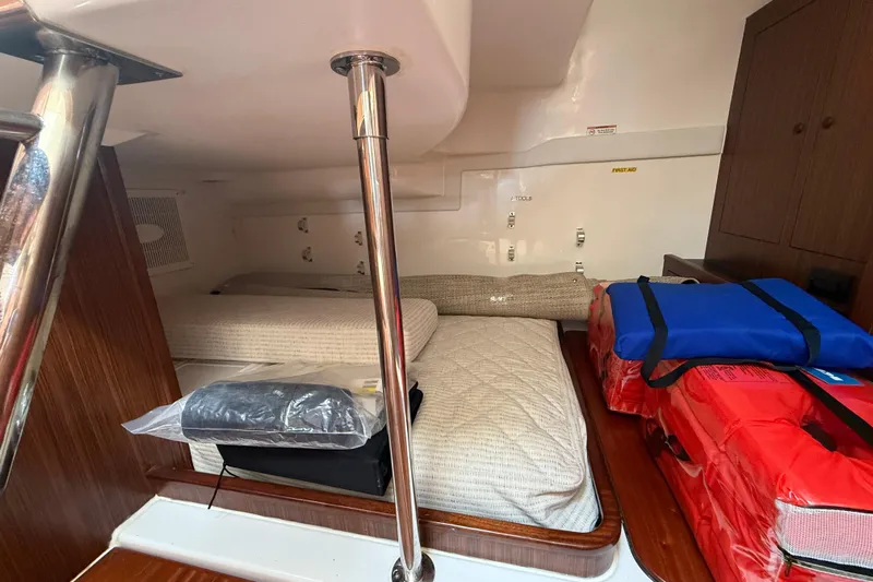 Centra Yacht Photos Pics 2023 Pursuit OS 355 Offshore cabin interior with bedding and safety equipment.