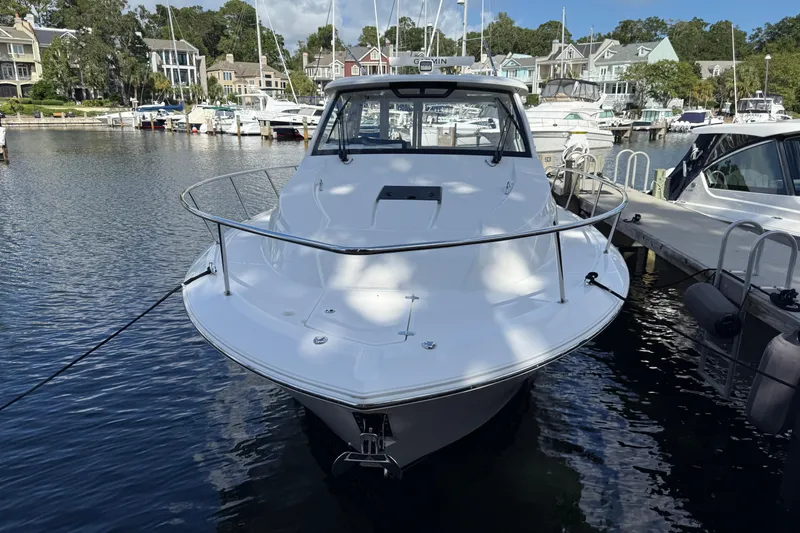 Centra Yacht Photos Pics 2023 Pursuit OS 355 Offshore boat docked in a marina, surrounded by other vessels.