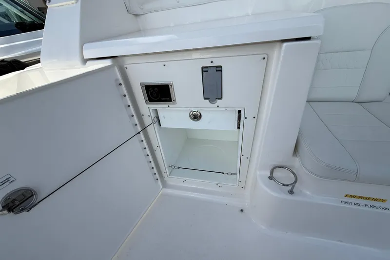 Centra Yacht Photos Pics 2023 Pursuit OS 355 Offshore boat interior storage compartment with emergency equipment.