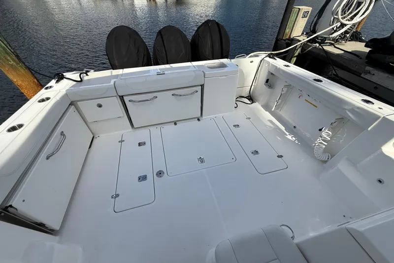 Centra Yacht Photos Pics 2023 Pursuit OS 355 Offshore boat deck with storage compartments and clean white finish.