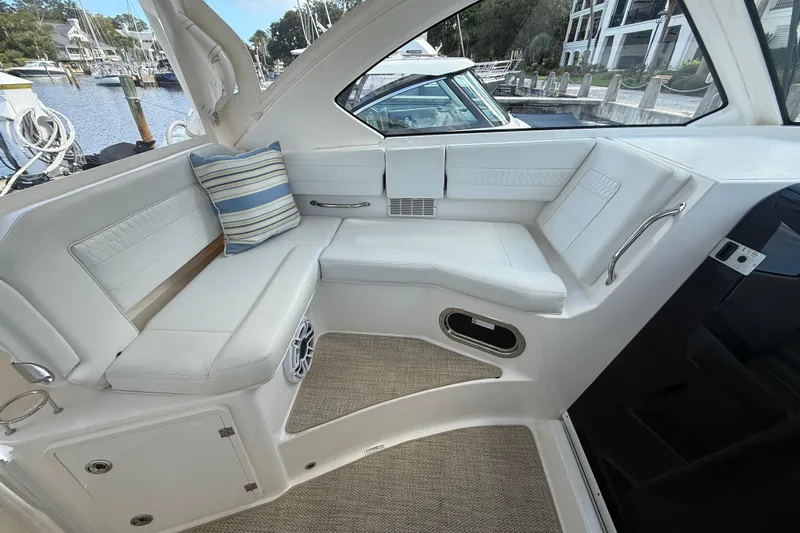 Centra Yacht Photos Pics 2023 Pursuit OS 355 Offshore boat interior with white seating and striped cushion.