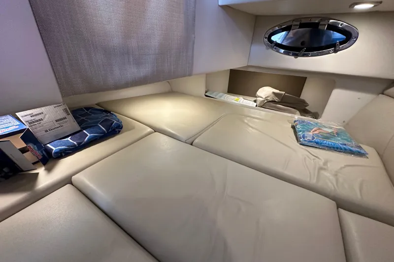  Yacht Photos Pics 2016 Formula 330 Crossover Bowrider cabin interior with cushioned seating and porthole window.