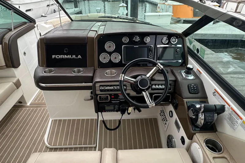  Yacht Photos Pics 2016 Formula 330 Crossover Bowrider dashboard with steering wheel and navigation controls.