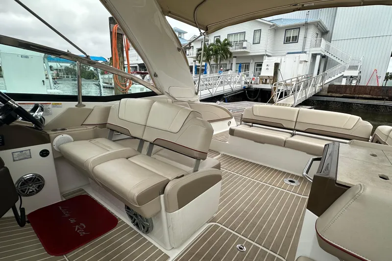  Yacht Photos Pics 2016 Formula 330 Crossover Bowrider interior with beige seating and wood-style flooring.