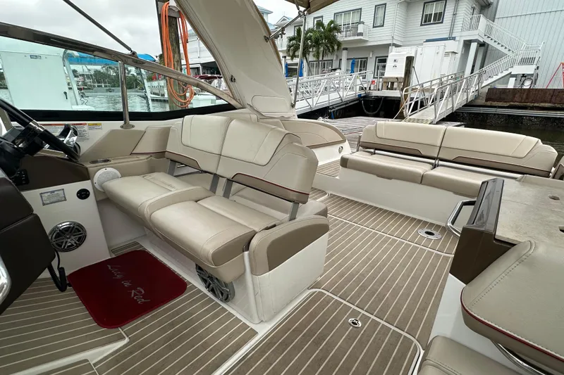  Yacht Photos Pics 2016 Formula 330 Crossover Bowrider interior with beige seating and wood-style flooring.
