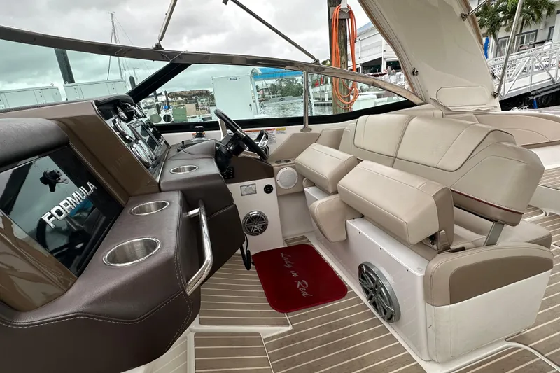  Yacht Photos Pics 2016 Formula 330 Crossover Bowrider interior with beige seating and modern dashboard.