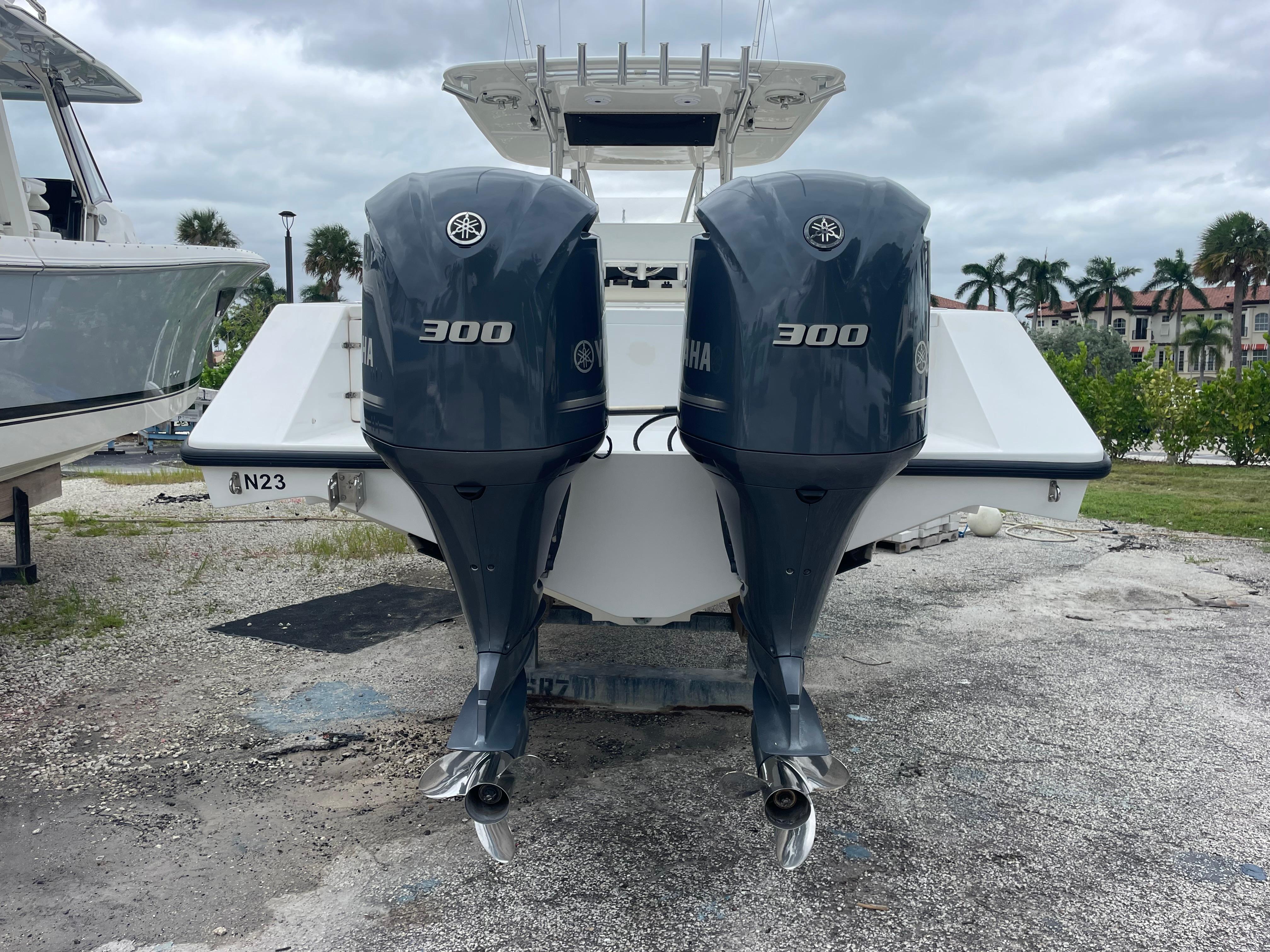 2000 Venture 34 Tournament boat with twin Yamaha 300 engines, parked outdoors.