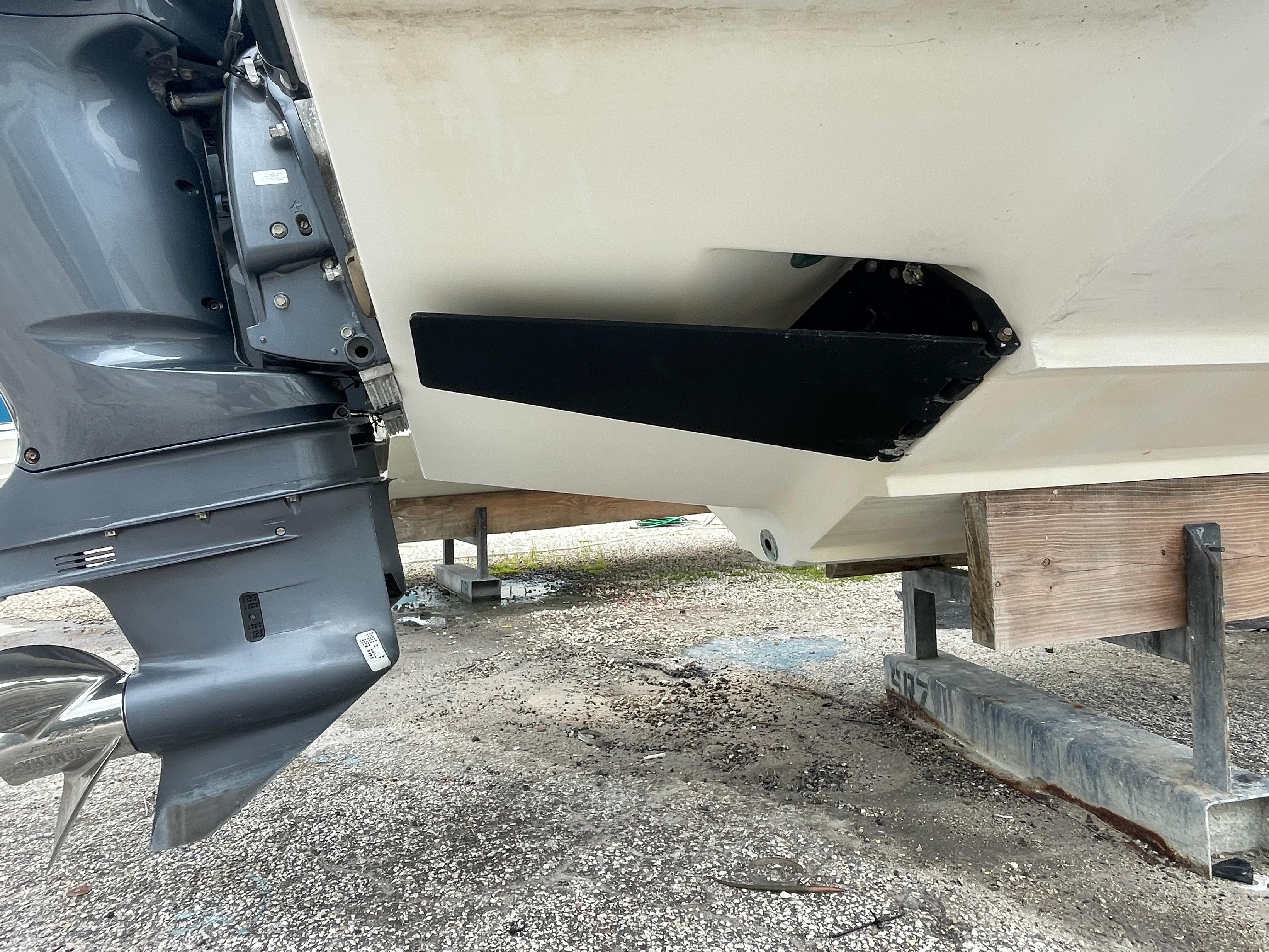 2000 Venture 34 Tournament boat stern with outboard motor on dry dock.