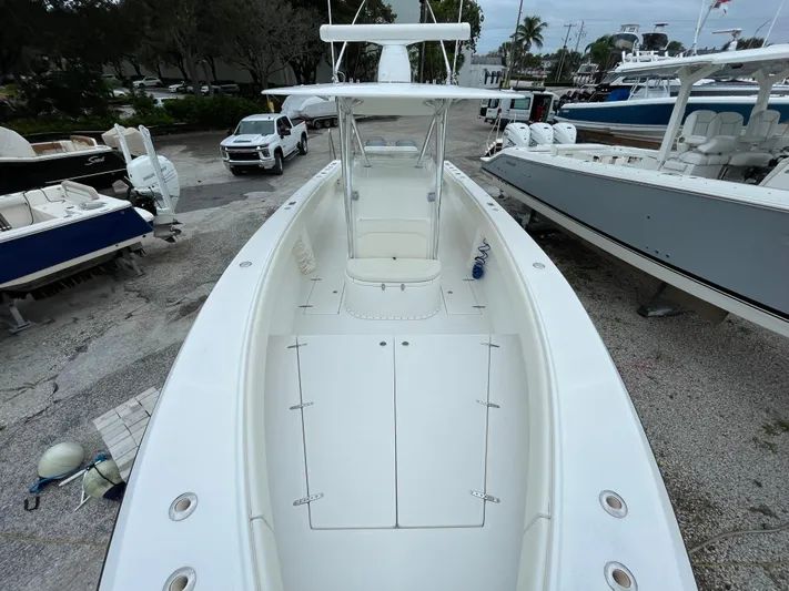  Yacht Photos Pics 2000 Venture 34 Tournament boat, white deck, parked among other boats.