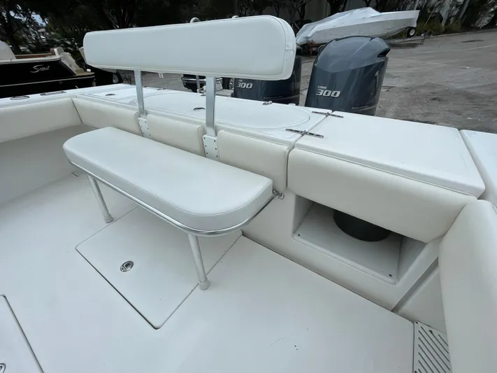  Yacht Photos Pics Venture 34 Tournament 2000 boat seating area with white cushions and storage compartment.