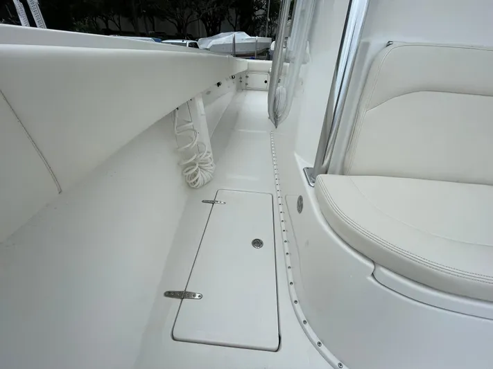  Yacht Photos Pics Venture 34 Tournament 2000 boat interior with white seating and storage compartment.