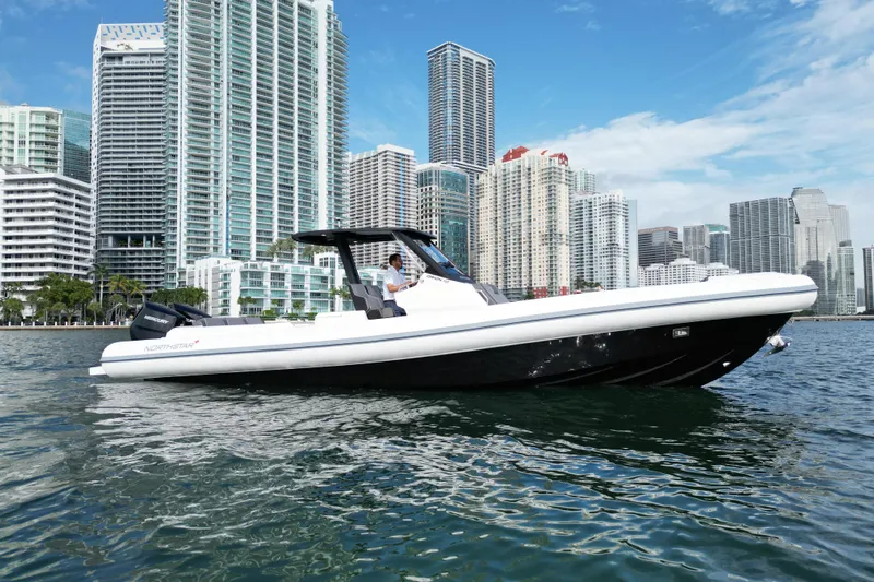  Yacht Photos Pics 2026 Northstar ORION 10 boat cruising near city skyline on a sunny day.