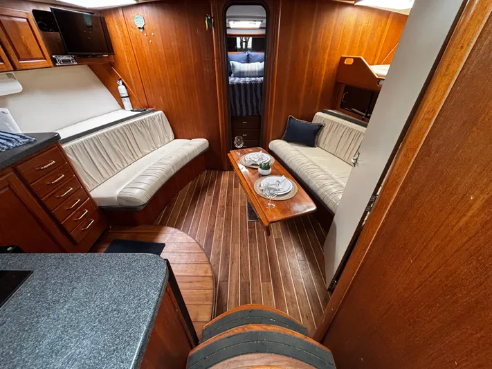 Martuni Yacht Photos Pics 2002 Luhrs 40 Open yacht interior with wood paneling, seating, and dining area.