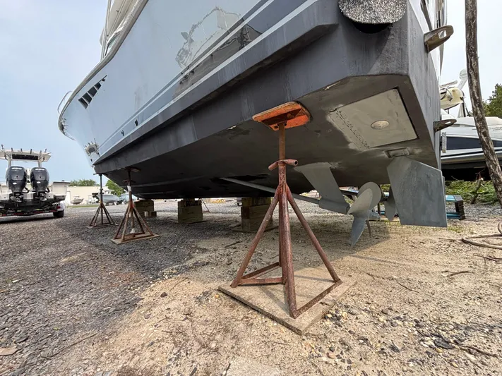 Martuni Yacht Photos Pics 2002 Luhrs 40 Open boat on stands, showing hull and propeller in a boatyard.