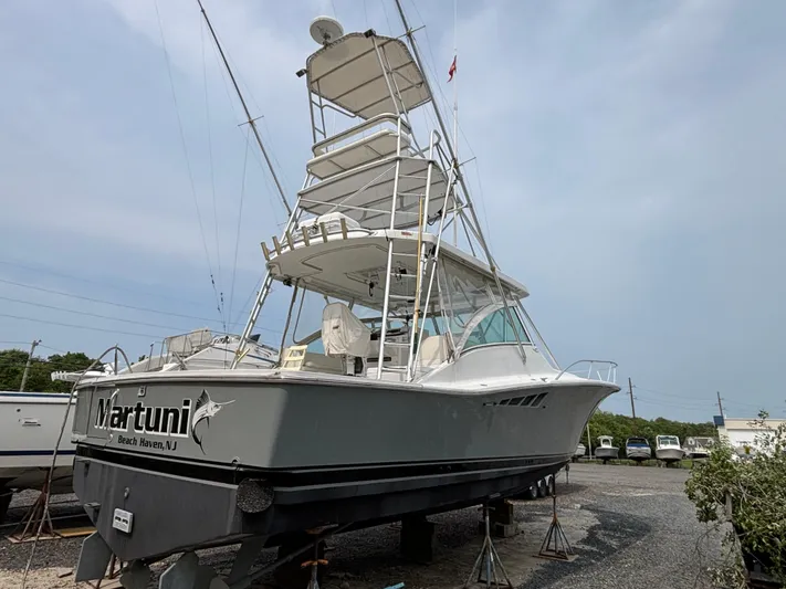 Martuni Yacht Photos Pics 2002 Luhrs 40 Open boat on stands, side view, with tower and fishing gear.