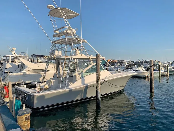 Martuni Yacht Photos Pics 2002 Luhrs 40 Open boat docked at a marina under clear blue skies.