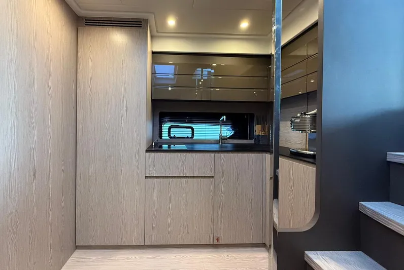  Yacht Photos Pics Modern kitchen interior of 2019 Azimut Atlantis 45 yacht, featuring sleek cabinetry and ambient lighting.
