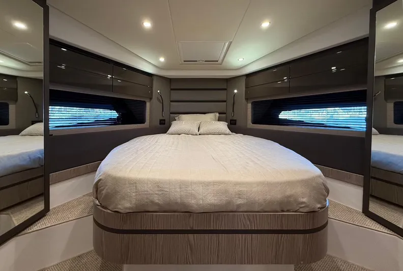  Yacht Photos Pics Luxurious bedroom interior of 2019 Azimut Atlantis 45 yacht with modern design and ambient lighting.