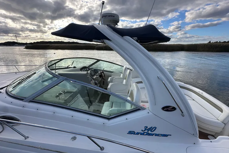  Yacht Photos Pics 2006 Sea Ray 340 Sundancer boat on calm water under cloudy sky.