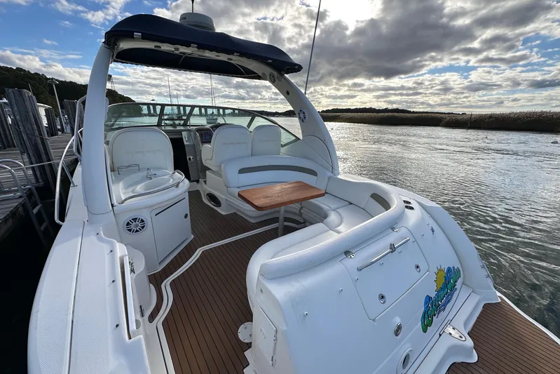  Yacht Photos Pics 2006 Sea Ray 340 Sundancer boat with spacious deck and seating, docked by the water.