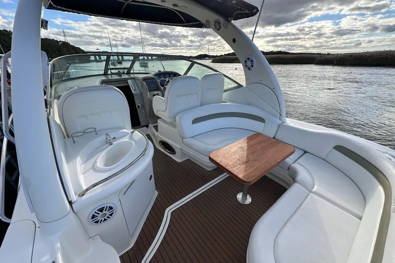  Yacht Photos Pics 2006 Sea Ray 340 Sundancer boat interior with seating, table, and water view.