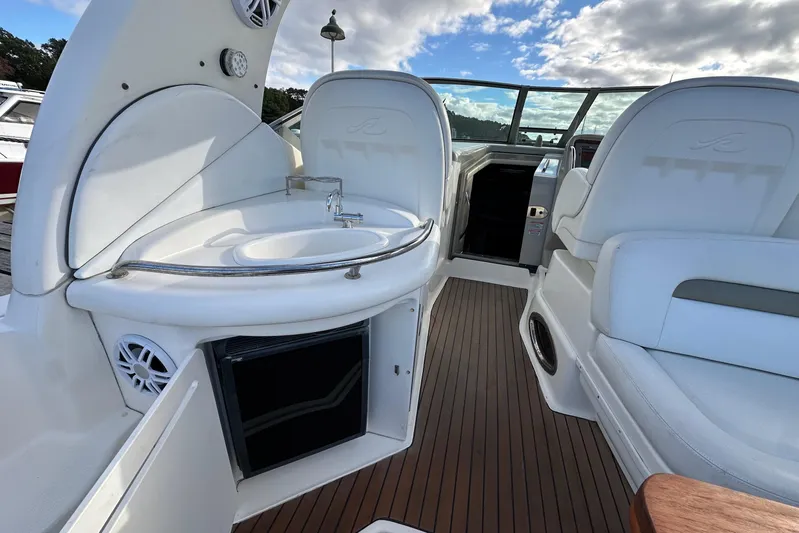  Yacht Photos Pics 2006 Sea Ray 340 Sundancer interior with sink, seating, and wooden flooring.