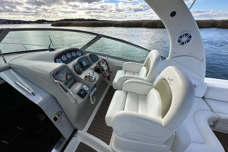  Yacht Photos Pics 2006 Sea Ray 340 Sundancer helm with white seats and modern controls on the water.