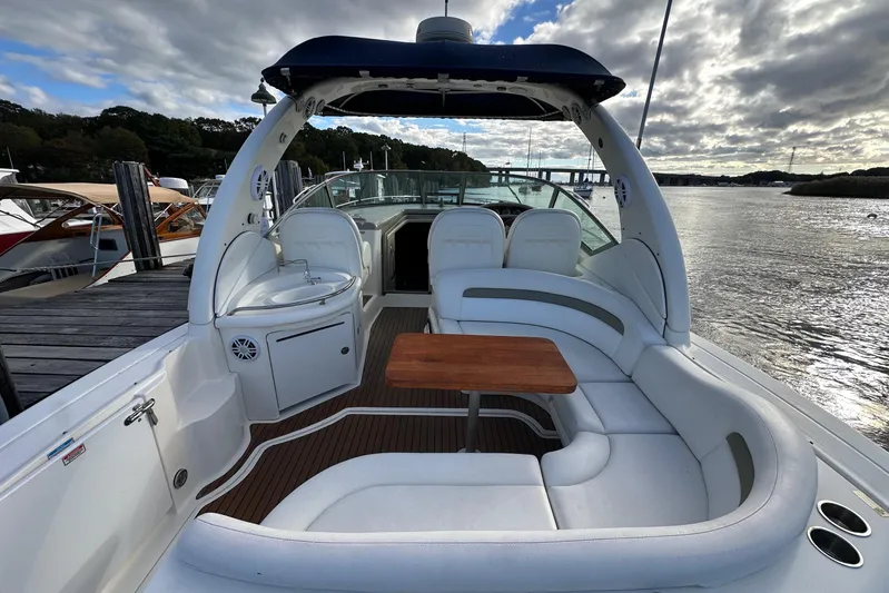  Yacht Photos Pics 2006 Sea Ray 340 Sundancer yacht with spacious seating and wooden table on deck.