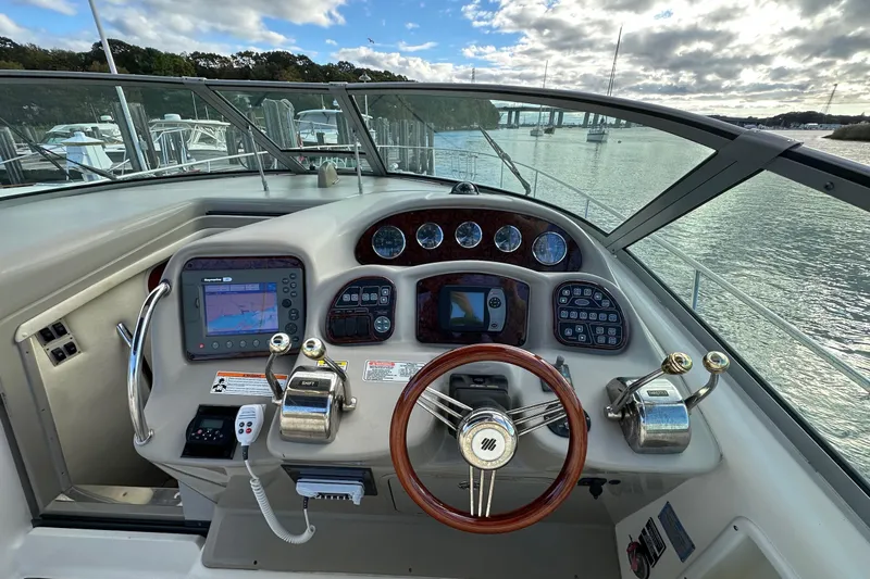  Yacht Photos Pics 2006 Sea Ray 340 Sundancer helm with navigation controls and scenic water view.