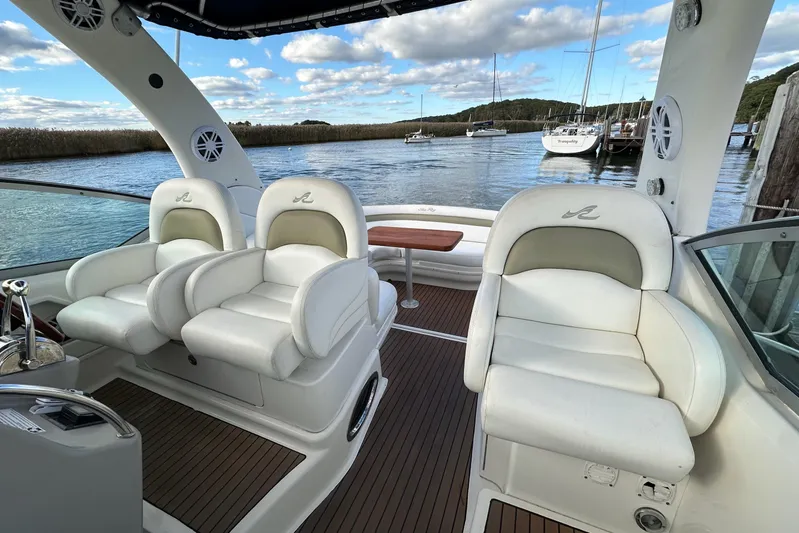  Yacht Photos Pics 2006 Sea Ray 340 Sundancer cockpit with white seating, wooden deck, and scenic water view.