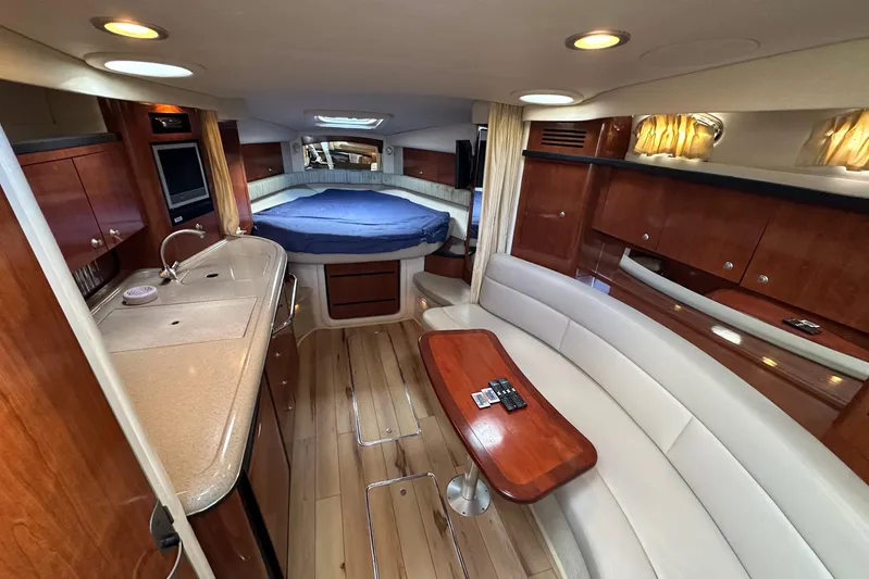  Yacht Photos Pics Luxurious interior of 2006 Sea Ray 340 Sundancer yacht with wood finishes and cozy seating.