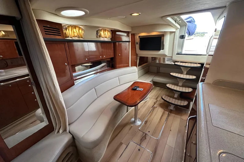  Yacht Photos Pics Interior of 2006 Sea Ray 340 Sundancer yacht with elegant seating and wooden cabinetry.