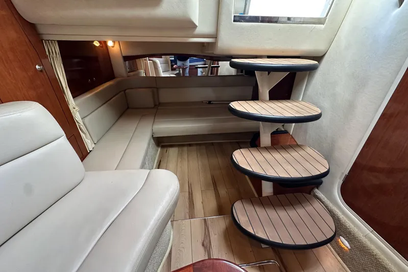  Yacht Photos Pics 2006 Sea Ray 340 Sundancer interior with wooden steps and beige seating.