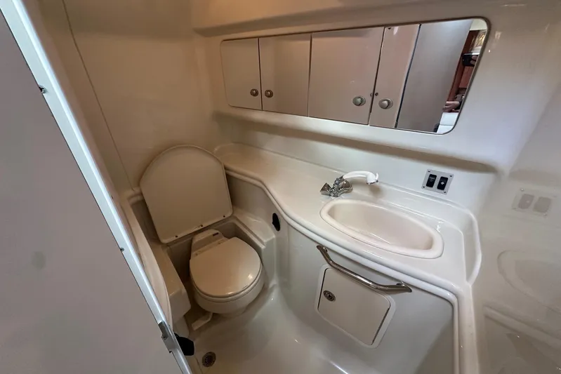  Yacht Photos Pics 2006 Sea Ray 340 Sundancer bathroom with toilet, sink, and storage cabinets.