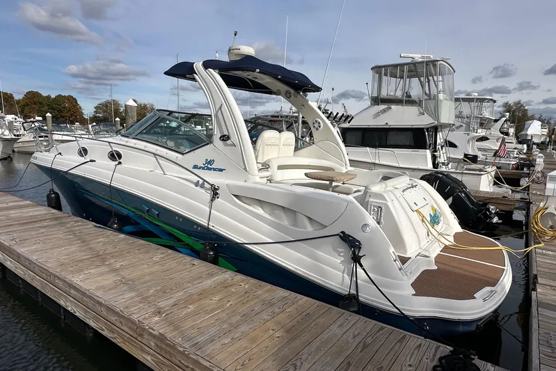  Yacht Photos Pics 2006 Sea Ray 340 Sundancer docked at marina, featuring sleek design and spacious deck.