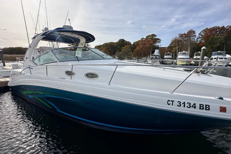  Yacht Photos Pics 2006 Sea Ray 340 Sundancer docked at marina, surrounded by other boats.