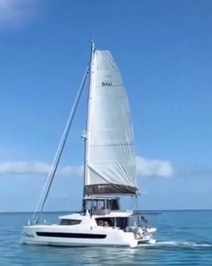 C Dreams Yacht Photos Pics Sailing catamaran Bali 4.6, 2022 model, cruising on calm blue ocean under clear sky.