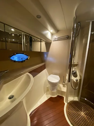  Yacht Photos Pics Luxurious bathroom in 2001 Fairline Squadron 55 yacht with modern fixtures and wooden flooring.