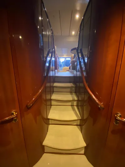  Yacht Photos Pics Staircase inside 2001 Fairline Squadron 55 yacht with wooden paneling and elegant design.