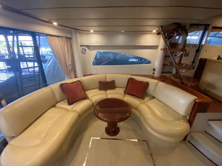  Yacht Photos Pics Luxurious interior of 2001 Fairline Squadron 55 yacht with elegant seating and wooden accents.