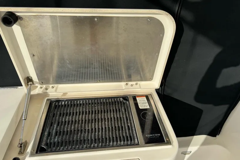  Yacht Photos Pics 2009 Pursuit OS 375 Offshore boat grill with open lid, featuring Kenyon Custom grill.