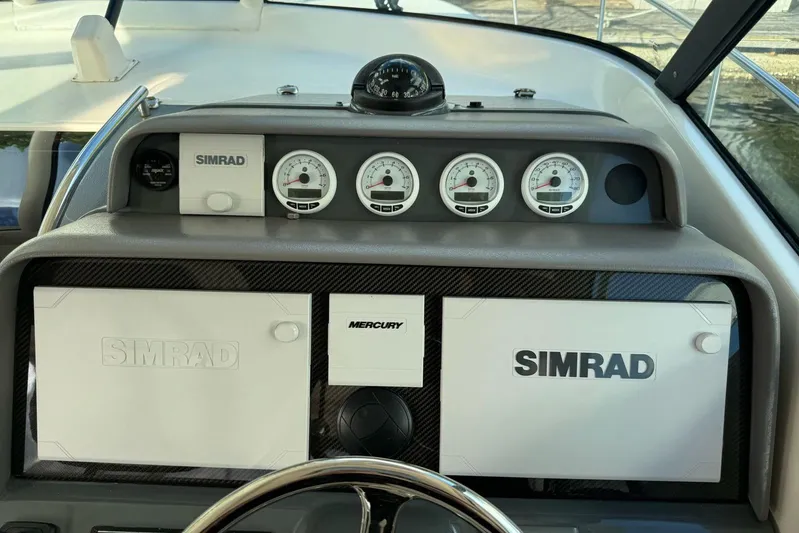  Yacht Photos Pics Dashboard of a 2009 Pursuit OS 375 Offshore boat with Simrad and Mercury instruments.